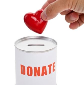 Generic image of a donation box. A hand is depositing a red heart-shaped token
