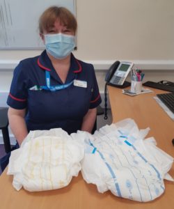 Teresa Woollerton wearing mask showing continence products