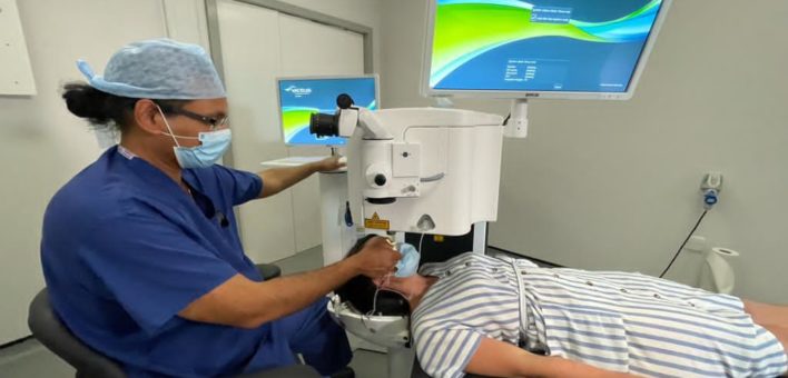 Photograph of Dr Hatch Mukherjee using the laser eye surgery equipment