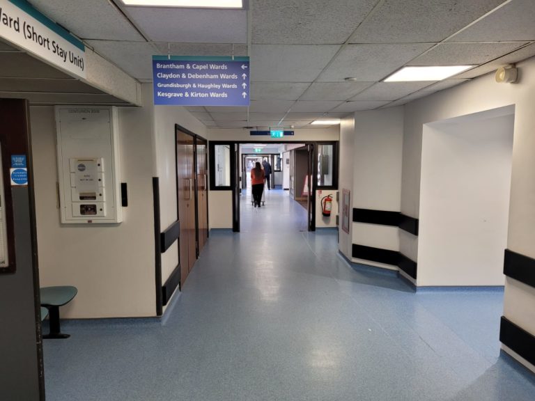 A generic shot of a corridor and ward signs at the south end of Ipswich Hospital.