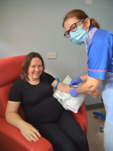 Pregnant woman in chair with maternity research midwife