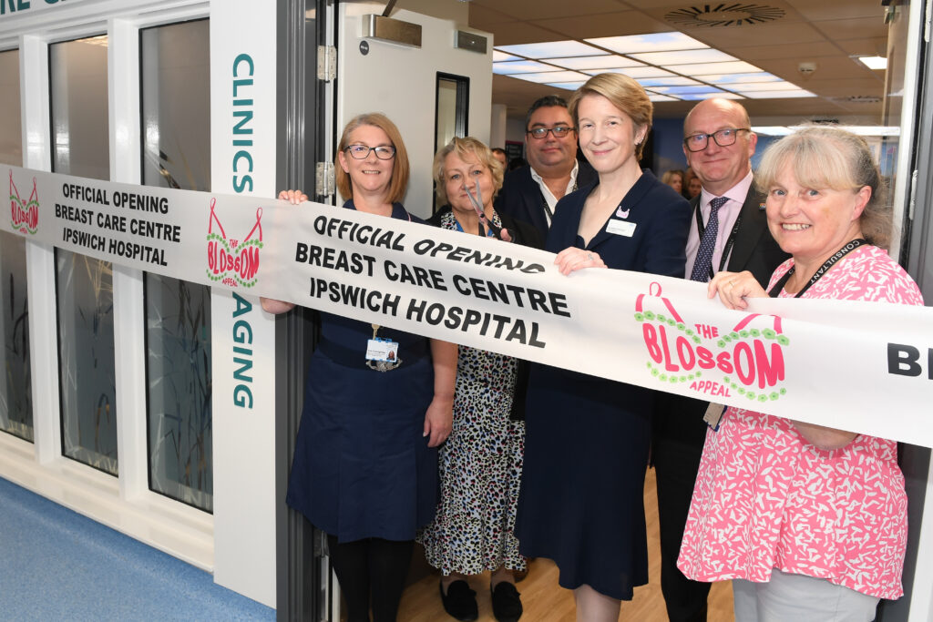 Amanda Pritchard cuts the ribbon to open the new Breast Care Centre, accompanied by several other people.
