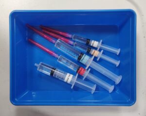 Blue plastic tray with syringes