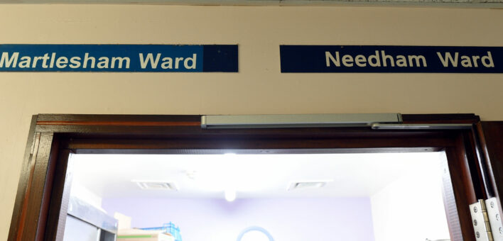 Two signs above a hospital ward entrance