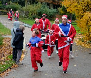 People dressed as Santa Claus taking part in a fun run