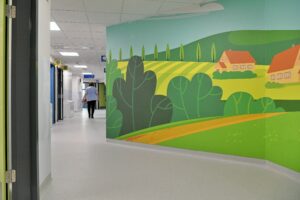 A countryside mural on the wall in a corridor in the new children's department