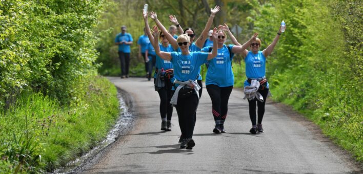 People wearing charity t-shirts walking through the countryside
