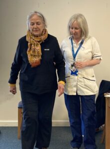 A patient takes part in a walking assessment with a physiotherapist