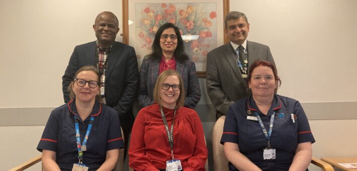 A group of Ipswich Hospital NHS staff stand together smiling